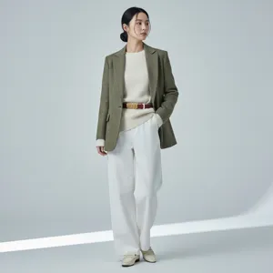 Elegant women's leather belt with metallic bar buckle, styled for modern chic looks.