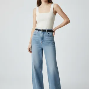 Stylish women's jeans with a classic black leather belt, casual high-waisted denim outfit.