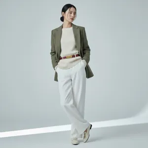 Stylish women's outfit featuring an olive green blazer, beige knit sweater and white trousers.