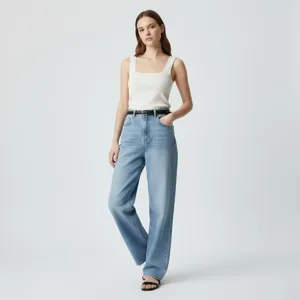 Detailed shot showing casual blue denim jeans and white top outfit on model in studio setting