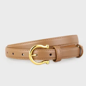Brown leather belt detail shot showcasing a polished gold-tone horseshoe buckle accessory.