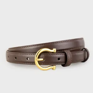 Close-up of brown leather belt with polished gold horseshoe buckle and neat stitching details.