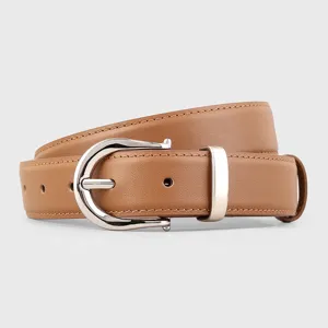 Brown leather belt detail, classic horseshoe metal buckle, elegant women accessory design.
