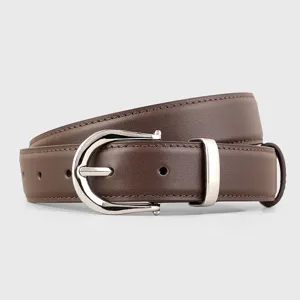 Detail shot of brown leather belt with silver buckle, premium craftsmanship and texture.