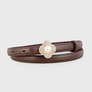 Detail shot of brown leather thin belt with rhinestone pearl clover buckle accessory.