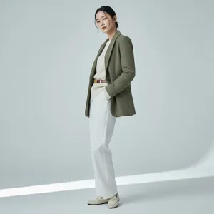 Stylish women's olive green blazer outfit with chic belt and white trousers for daily look.