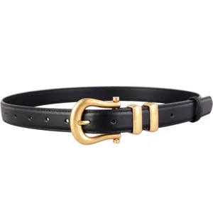 Women's minimalist black leather belt with gold horseshoe buckle for dress and jeans.