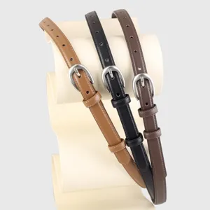 Detailed view of women slim leather belts with metal pin buckles in three classic colors.