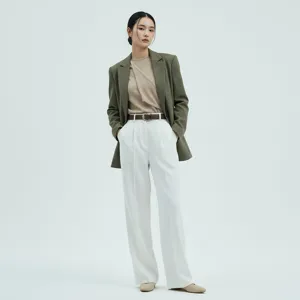Detail view of womens brown leather belt styled with outfit in professional studio shot.