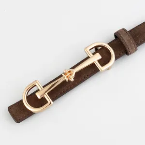 Slim brown suede belt featuring a classic gold-tone horsebit buckle for chic vintage styling.