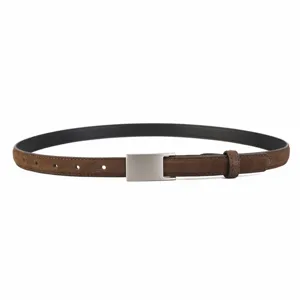 Detail shot of the brown suede women's belt with a sleek silver buckle, premium texture.
