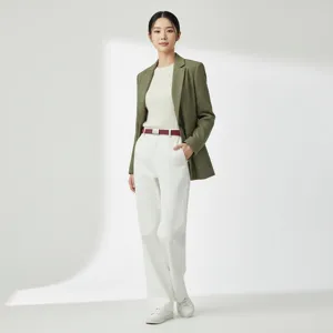 Detailed view of casual outfit featuring green blazer, red belt, and white trousers for women.