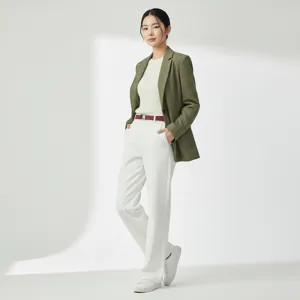 Detailed view of a fashionable red belt styled with professional outfit and white trousers.