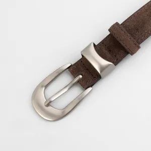 Closeup of brown suede belt with silver metal buckle, premium texture apparel detail accessory