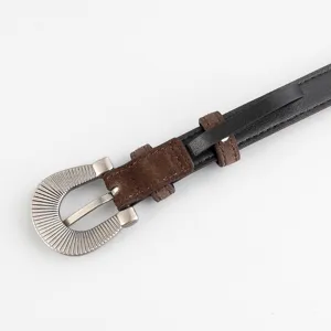 Detailed view of women's retro metal buckle belt with black and brown contrast design.