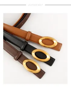 Detailed shot of women genuine leather belt featuring elegant oval gold buckle stylish design.