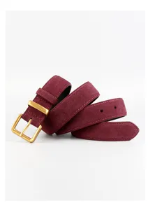 Burgundy suede belt close-up detail, velvet texture with matte gold buckle for women.