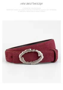 Detailed view of wine red genuine leather women belt with unique irregular alloy buckle.