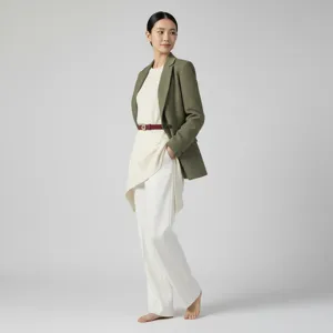 Detailed view of a stylish women's outfit featuring a sleek belt, blazer, and trousers.