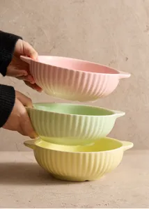 Ceramic bowl detail shot showcasing vertical ribbed design and pastel colors for kitchen.