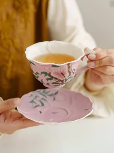 Hand-painted pink butterfly ceramic coffee cup and saucer set, elegant afternoon tea detail.