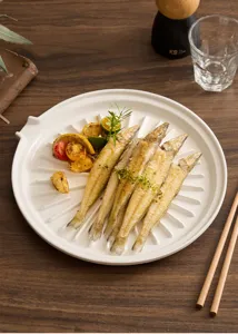 Detailed shot of white ceramic drainage plate, premium food serving plate with oil grooves.