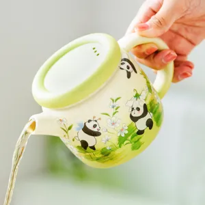 Cute ceramic panda teapot with floral illustration for home kung fu tea brewing and daily use.