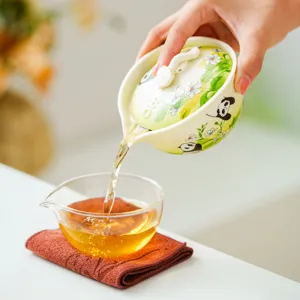 Portable ceramic travel tea set with cute panda and flower design for outdoor camping or home use.