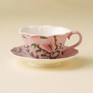 Hand-painted pink ceramic coffee cup and saucer set with butterfly and rose floral design.