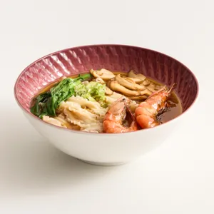Elegant ceramic noodle bowl with unique plaid pattern interior, perfect for home ramen and soups.