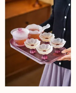 Close-up of pink lotus glass tea set detail, elegant frosted design, perfect home tea experience.