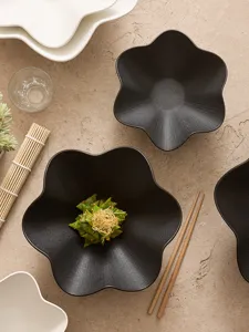 Detailed close-up of textured ceramic plum blossom bowl in a stylish dining table setup.