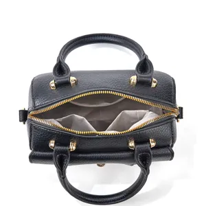 Detailed view of black leather handbag interior, showing zippered top and lining pockets.