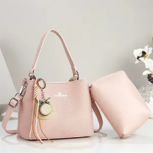 Pink women's shoulder bag large capacity commuting casual handbag with matching pouch.