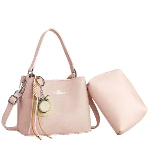 Stylish pink herringbone shoulder bag, casual commuter tote with pouch and charm.