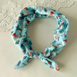 Detailed view of the blue Christmas snowflake patterned knotted headband fabric texture.