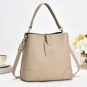 Detaillierte Ansicht der eleganten beigen Beuteltasche mit Metallschließe und Schulterriemen.