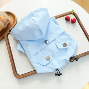 Light blue waterproof pet raincoat detail for small dogs puppies with hood and pockets.