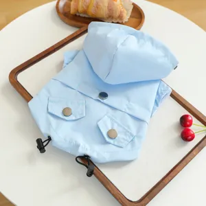 Light blue waterproof hooded pet raincoat for small dogs, cute outdoor puppy apparel with pocket.