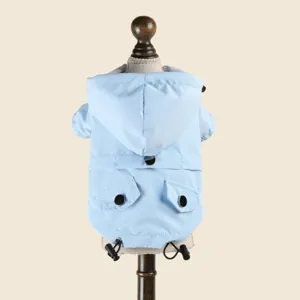 Light blue waterproof dog raincoat with hood and pockets for small puppies, detail view.