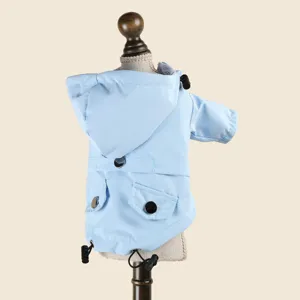 Light blue pet raincoat for small dogs, waterproof hooded puppy jacket with cute pocket details.