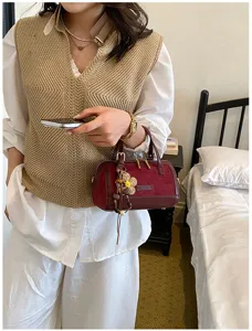 Chic burgundy boston handbag for women, stylish suede crossbody bag for office work.