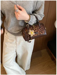 Leopard print pillow crossbody bag with cute flower charm, stylish daily casual handbag.