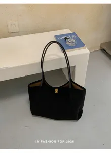 Classic black large capacity tote bag with minimalist design and chic shoulder straps.