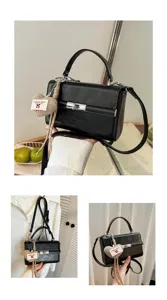 Korean style black small square handbag for women with knitted heart pendant and shoulder strap.
