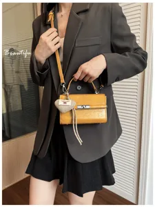 Korean style niche yellow small square handbag with handle and crossbody strap for women.