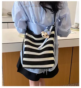 Casual black and white striped woven tote bag with cute bear pendant for women daily commuting.