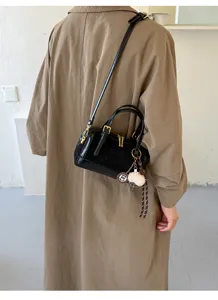 Chic black boston pillow bag for women, trendy crossbody shoulder handbag with stylish charm.