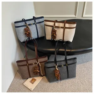 Large capacity retro women tote bag with cute bear pendant, stylish autumn commuting handbag.