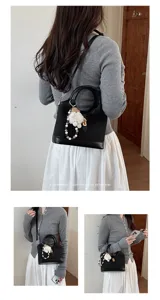 Korean style black commuter handbag with pearl charm, stylish shoulder and crossbody bag for women.